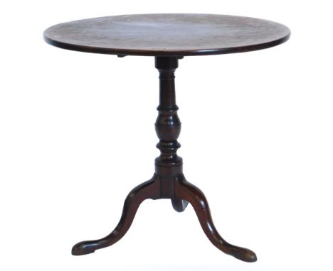 An early 19thC mahogany occasional table, with a circular top on a turned column and tripod base with pad feet, 77cm diameter