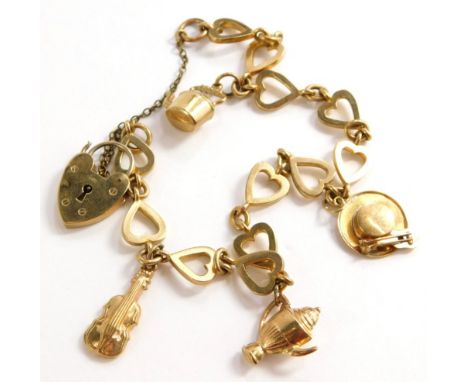 A charm bracelet, with various heart shaped links, each stamped 9c, with a heart shaped padlock and various charms, to includ