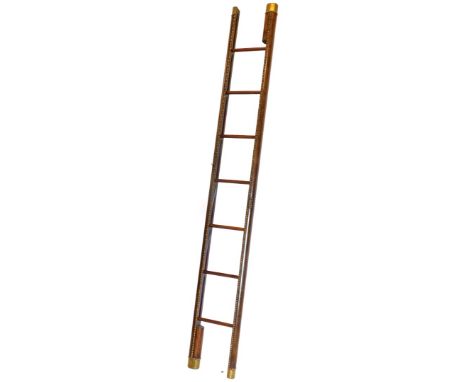 A folding mahogany and pressed leather folding library ladder, with a beaded outline and brass ends and plain horizontal spok
