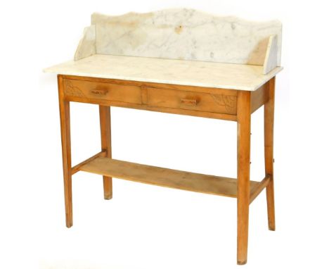 An Art Deco beech washstand, with a white marble top, with two frieze drawers on tapering legs with under tier, 100cm wide.