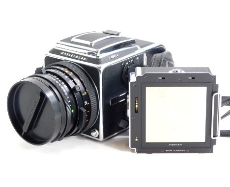 A Hasselblad 503CX camera, with Zeiss Planar f2.8 80mm lens, two A12 film backs and lens hood, in a camera bag.