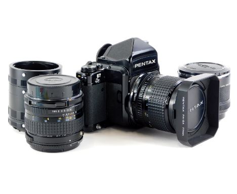 A Pentax 67 camera, with 55mm f4 SMC lens and hood, and a 165mm f4 SMC lens, with a set of auto extension tubes.