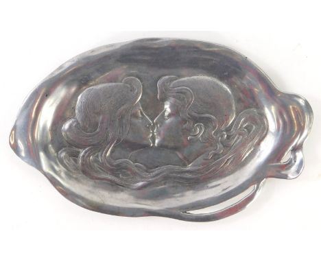 An Art Nouveau pewter oval dish, with two figures about to kiss, 27cm.