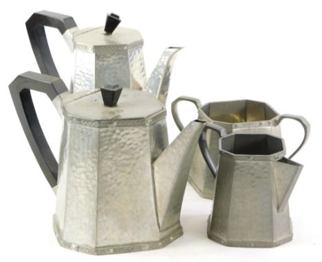 An Art Deco hand beaten pewter four piece coffee service, of angular form with black Bakelite handles.