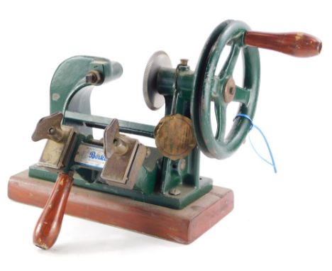A Börkey key cutting machine, with green enamel paint on a rectangular base, 40cm long.