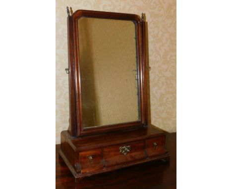 A George III mahogany dressing table mirror, with rectangular plate and three shaped frieze drawers, on bracket feet, 40cm wi