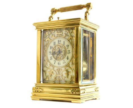 A late 19thC/early 20thC French carriage clock, the cream coloured dial applied with Gothic motifs, the case with bevelled gl