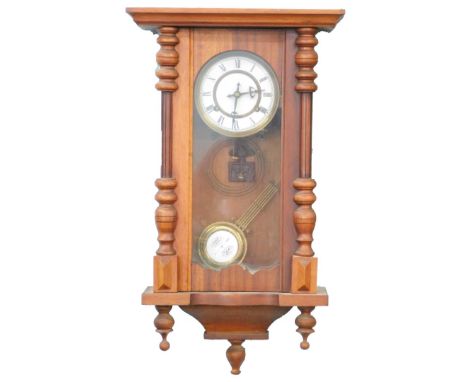 An early 20thC mahogany cased Vienna type wall clock, with white enamel dial, 65cm high.