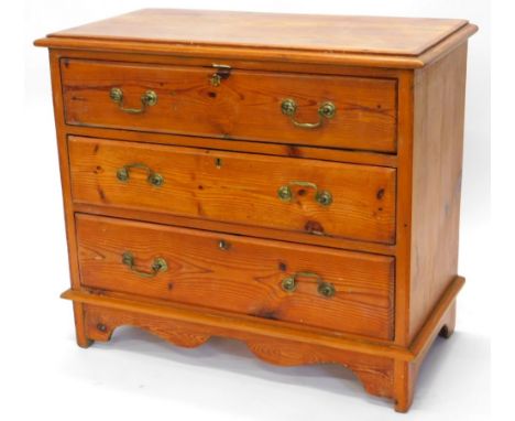 A pine chest of drawers, top with a moulded edge, above three long drawers with brass drop handles on bracket feet, 78cm high