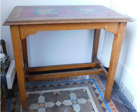 An Edwardian oak occasional table, with an Art Nouveau tile top, 76cm x 45cm.