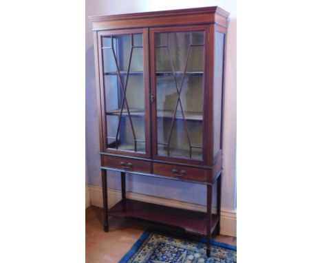 An Edwardian string inlaid mahogany display cabinet, with two astragal glazed doors, over two drawers on square taper legs, w