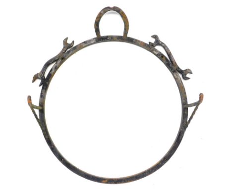 A blacksmith made wrought iron wall display bracket, decorated with horseshoes and spanners, with two arms, possibly for a si