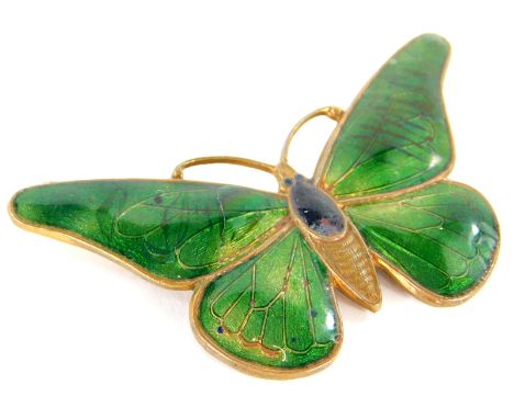 A continental Art Deco brass and enamel butterfly brooch, with green wings, unmarked, 6cm wide.