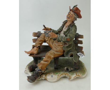 Large Capodimonte figurine of a man seated on a bench, bearing the blue backstamp