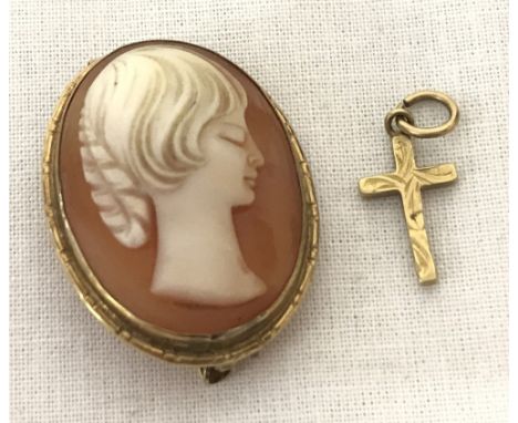An oval cameo brooch set in 9ct gold surround. Together with a small 9ct gold cross shaped pendant with engraved detail to fr