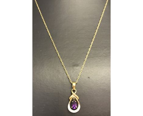 A 9ct gold decorative drop necklace set with amethyst and diamonds. Drop style pendant on a Singapore fine chain. Oval cut am