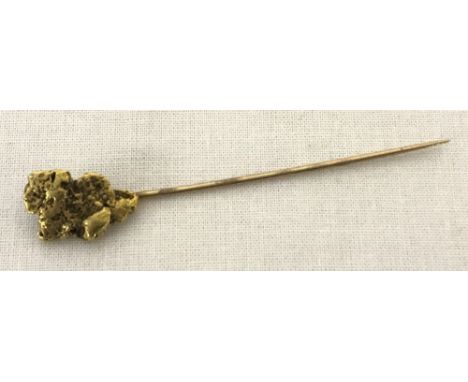 An unusual raw gold nugget stick pin. Pin tests as 14ct gold, nugget tests as 18ct gold. Total weight approx. 3.2g.