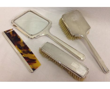 A vintage silver 4 piece dressing table set, hallmarked and with engine turned decoration. Comprising: hand mirror, hairbrush