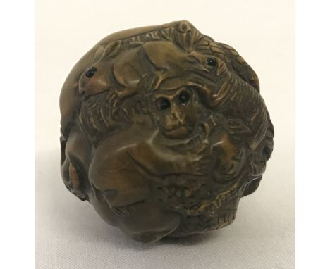 A signed carved wood, spherical shaped netsuke. Depicting the 12 animals of the Chinese Zodiac. Approx. 4cm diameter.
