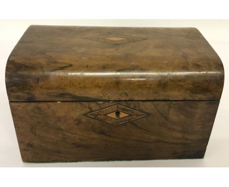 An antique walnut veneer, dome topped tea caddy with inlay decoration to lid and key hole. Complete with lids for interior co
