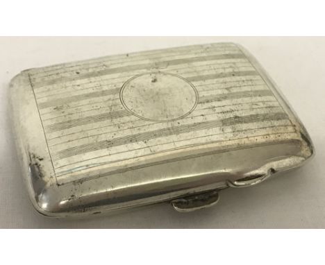 An antique silver cigarette case with engine turned decoration and circular empty cartouche. Silver gilt interior. Hallmarked