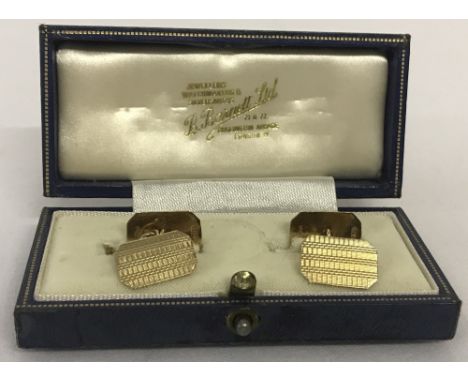A  boxed pair of 9ct gold cufflinks with engine turned decoration. Makers marks and hallmarks to reverse. Total weight 3.5g.