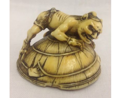 A 19th century Japanese ivory netsuke of an Oni capturing Shoki the demon queller's sword. Very finely carved. Oni is dressed