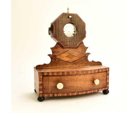 A 19th century inlaid mahogany watch standThe octagonal watch holder raised on a fret cut stand above a single bow-front draw