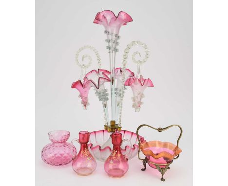 A Victorian cranberry glass epergne, cranberry and clear glass, the central frilled trumpet flanked by a pair of smaller trum