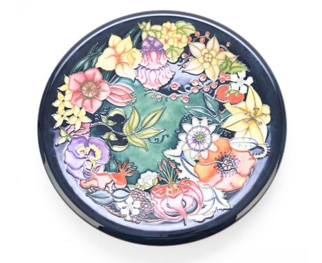 A Moorcroft charger in the Carousel pattern designed by Rachel Bishop, dated 1999, a numbered edition 734, 36cm diameter. Box