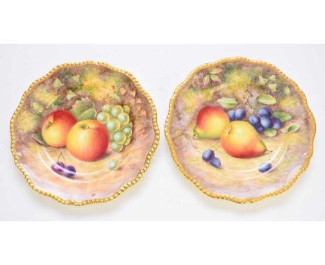 A pair of Royal Worcester fruit-decorated cabinet plates, of shaped circular form with a gilt-lined gadrooned rim, painted wi