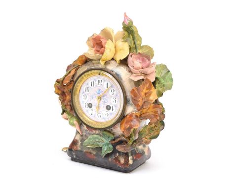 A French earthenware-cased mantel clock, early 20th centuryThe case applied with relief moulded flowers and foliage, the enam