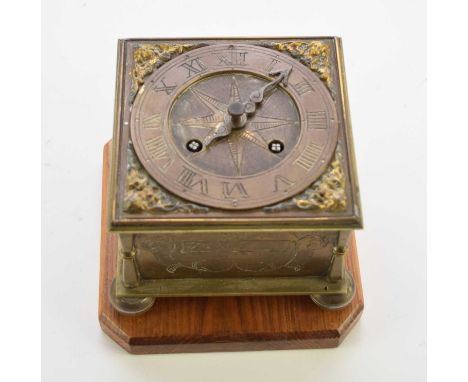 A reproduction brass horizontal table clock In the 16th century style, the square case etched to the sides with scrolling fol