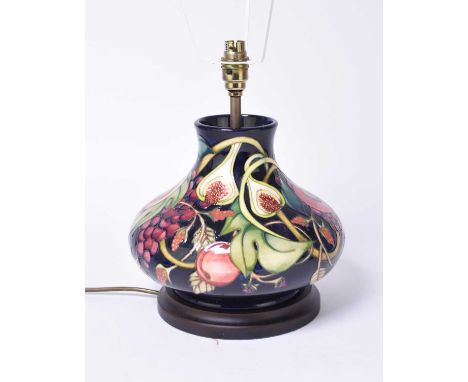 A Moorcroft lamp in the 'Queen’s Choice' pattern designed by Emma Bossons, of squat baluster form, with a shade, 23cm high in