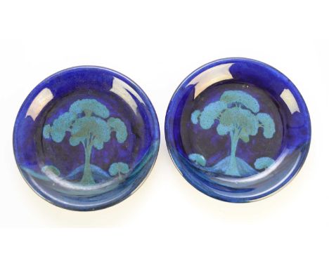 A pair of William Moorcroft 'Moonlit Blue' landscape plates, circa 1925, impressed marks, painted WM facsimile monogram, 22cm