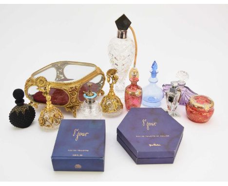 A collection of perfume bottles, including an Art Deco amethyst glass bottle with a clear stopper, 11.3cm high; a matt black 