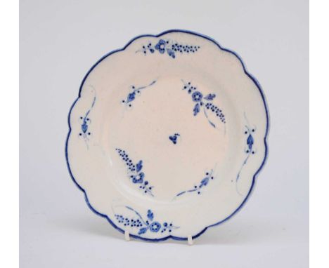 A Caughley 'Chantilly Sprigs' small plate, of lobed form, circa 1784-1795, painted in bright underglaze blue with French-styl