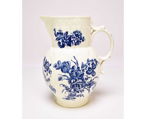 A Caughley 'Bouquets' cabbage leaf maskhead jug, circa 1780-85, transfer-printed in underglaze blue, unmarked, 19.5cm highPro