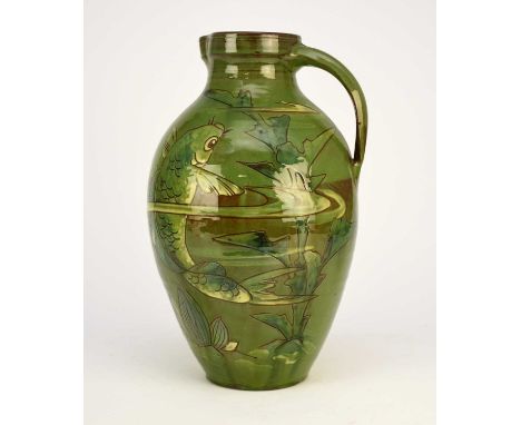 A large C H Brannam Barum Pottery green-glazed jug, decorated by William Baron with a large single carp underwater with pond 