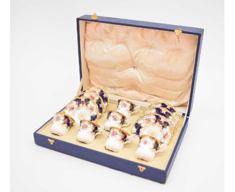 A Coalport cased blue batwing demitasse coffee service, circa 1920, comprising six cups and six saucers, in Waring and Gillow