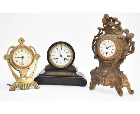 A French rococo revival cast brass mantel clock, 27cm high, together with a German cast brass strut type mantel clock, 25.5cm