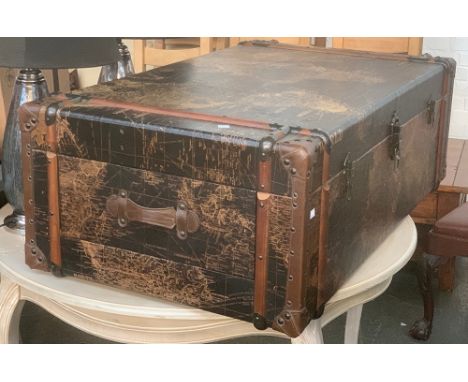 A coffee table in the form of a map clad travel trunk, 122x70x42cmH 