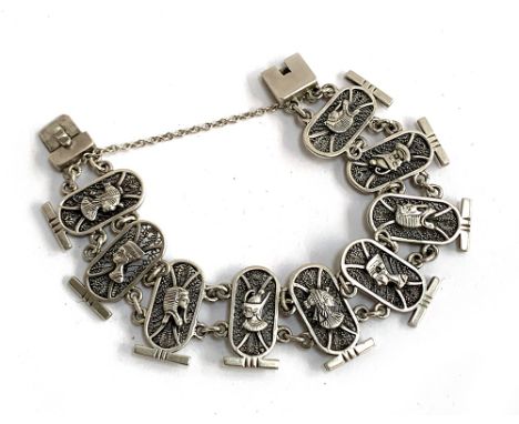 A 20th century Egyptian revival silver filigree panel bracelet, the panels depicting the heads of various Pharaohs, with Egyp