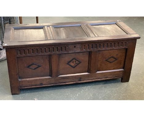 A three panel oak coffer, each panel with lozenge detail, 137x56x57cm 