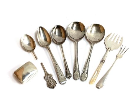 A small lot of silver, to include a bright cut Georgian teaspoon, London 1808; three 20th century spoons; a pickle fork; .925
