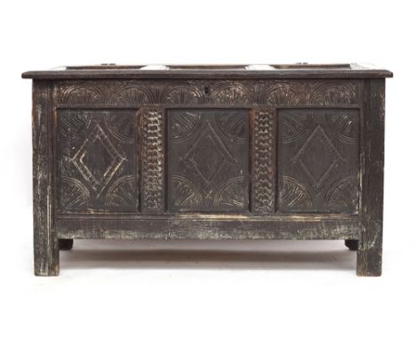 A 17th/18th century three panel oak coffer, carved with demilune frieze over three lozenge carved panels, 120cm wide, 56cm de