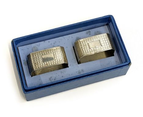 A pair of engine turned silver napkin rings, Birmingham 1960