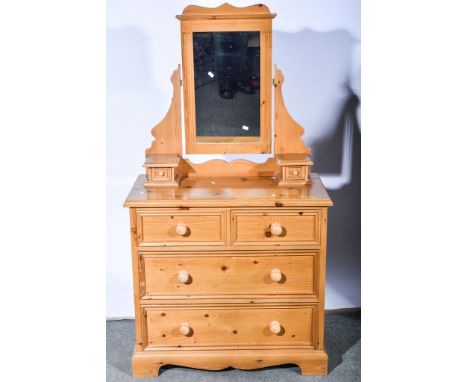 Modern pine dressing table, rectangular adjustable mirror above trinket drawers, base with a rectangular top and a moulded ed