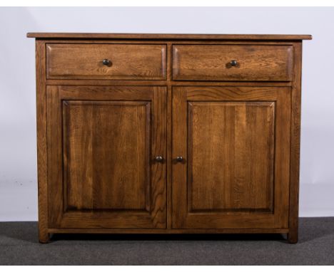 Reproduction oak sideboard, rectangular top, with four frieze drawers above carved linen fold panel cupboards, bracket feet.