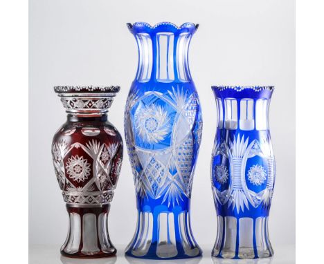 Pair of Bohemian ruby overlaid glass baluster-shaped vases, 33cms and two blue overlaid vases, (4).